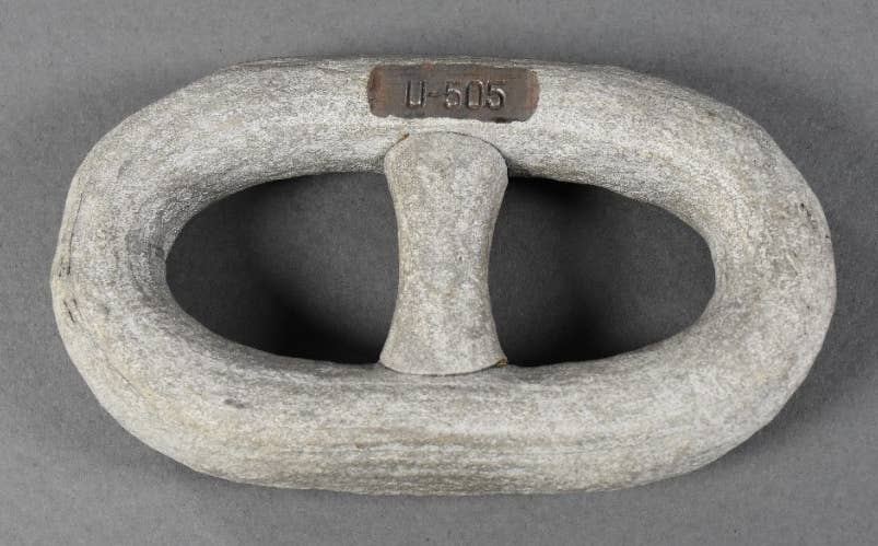 One anchor chain segment from the German submarine U-505. The link is painted white with an engraving marking its origins. (history.navy.mil)