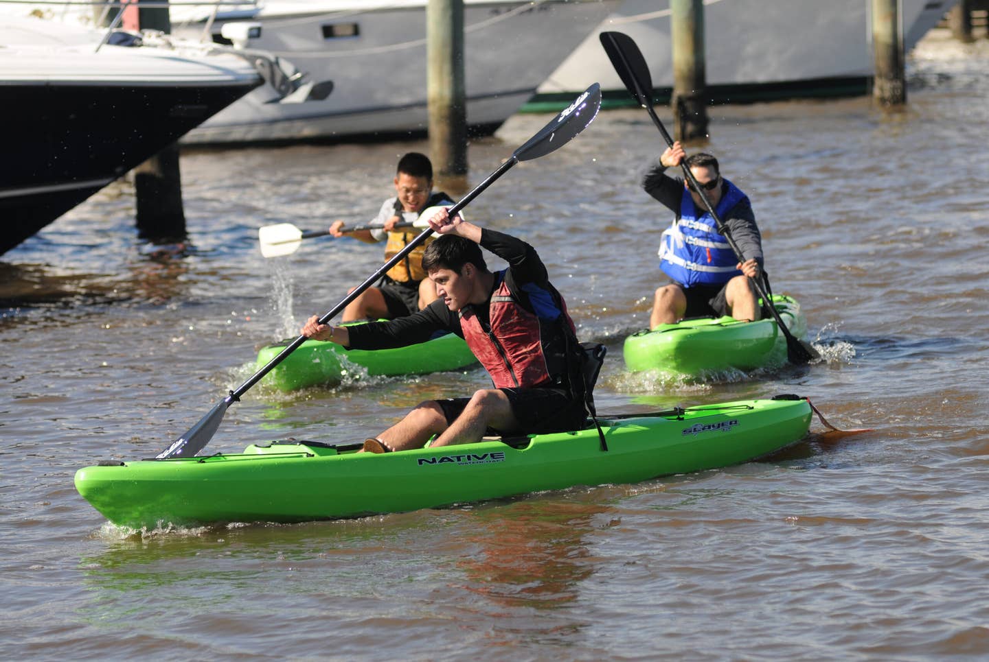 Second Lt. Jonathan Eng steers his kayak through the Keesler Marina as he is followed closely by 2nd Lt. Kyung Kim and Staff Sgt. Grant Coomes in the kayak races during the third annual Polar Bear Regatta Jan. 24, 2015, at marina park, Keesler Air Force Base, Miss.  Eng and Kim are students and Coomes is an instructor in the 333rd Training Squadron cyber warfare operations course. The event was sponsored by outdoor recreation.  (U.S. Air Force photo by Kemberly Groue/Released)
