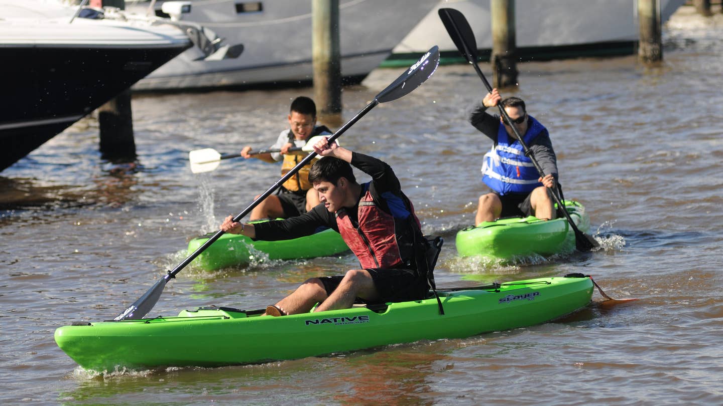 Second Lt. Jonathan Eng steers his kayak through the Keesler Marina as he is followed closely by 2nd Lt. Kyung Kim and Staff Sgt. Grant Coomes in the kayak races during the third annual Polar Bear Regatta Jan. 24, 2015, at marina park, Keesler Air Force Base, Miss.  Eng and Kim are students and Coomes is an instructor in the 333rd Training Squadron cyber warfare operations course. The event was sponsored by outdoor recreation.  (U.S. Air Force photo by Kemberly Groue/Released)
