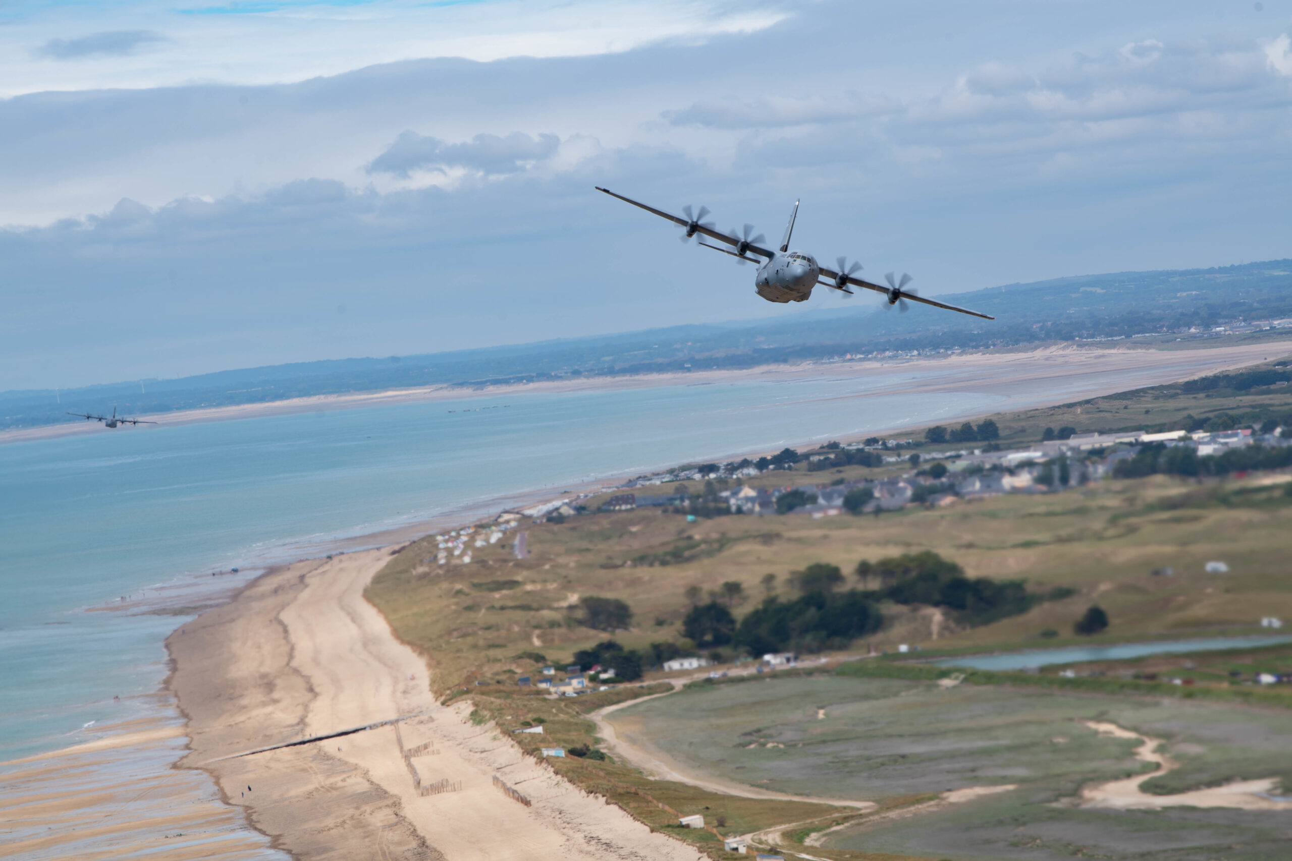 C-130J Super Hercules aircraft assigned to Ramstein Air Base, Germany, fly over the beaches of Normandy June 6, 2021. More than 150,000 soldiers from the Allied Forces stormed Normandy Beach and successfully changed the course of World War ll, June 6, 1944.