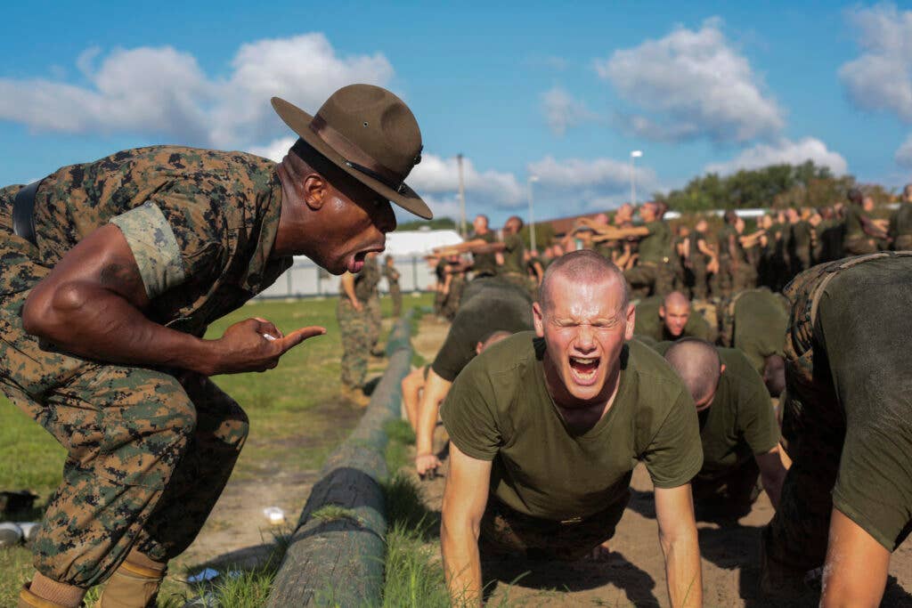 U.S. Marine Staff Sgt. Carlos Jones, senior drill instructor, Platoon 3102, Company I., 3rd Battalion, Recruit Training Regiment, instructs a recruit during a company Incentive Training session at the Recruit Training Facility sand pit on Marine Corps Recruit Depot, Parris Island, S.C., Sept. 20, 2016. Incentive Training builds endurance, strength, and discipline in a recruit throughout the course of recruit training. (U.S. Marine Corps photo by Pfc. Sarah Stegall/Released)