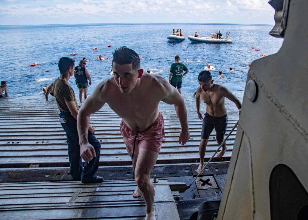 210822-N-YP246-1103 EAST CHINA SEA (Aug. 22, 2021) Sailors swim during a swim call aboard the amphibious transport dock ship USS Green Bay (LPD 20). Green Bay, part of Amphibious Squadron 11, is operating in the U.S. 7th Fleet area of responsibility to enhance interoperability with allies and partners and serve as a ready response force to defend peace and stability in the Indo-Pacific region. (U.S. Navy photo by Mass Communication Specialist 2nd Class Darcy McAtee/Released)