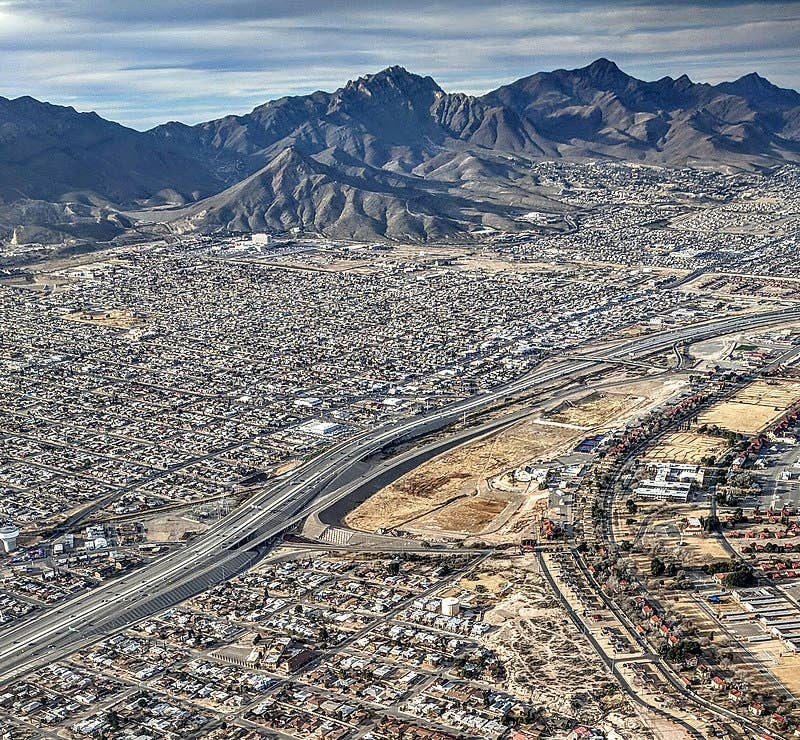Aerial view of El Paso with Fort Bliss's Armstrong Polo Field in the center. The Pershing Dam flood-control project floods the field when there is storm runoff. (Public domain)