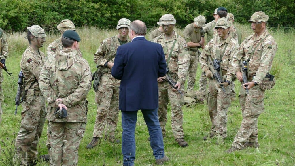 <em>Defence Secretary Ben Wallace speaks with British troops facilitating the training of Ukrainian troops in the UK (MOD)</em>