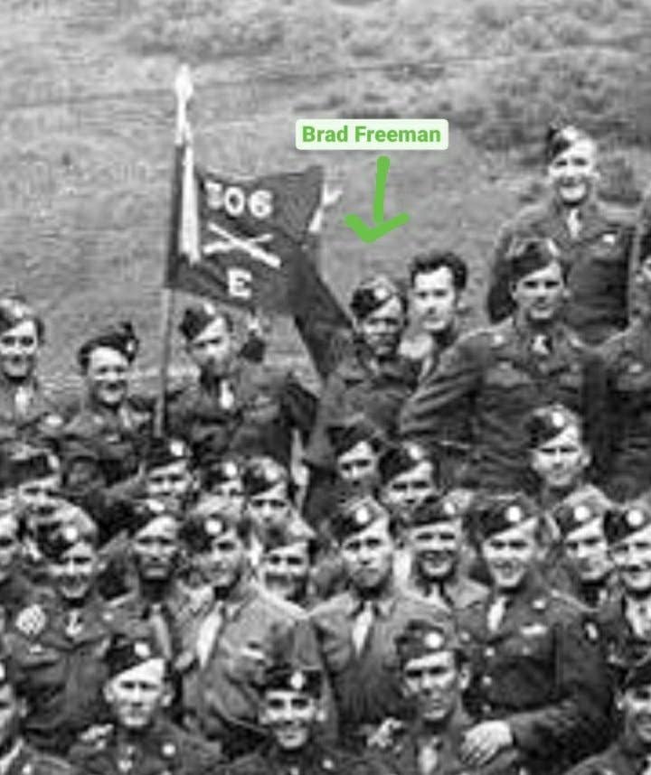 <em>Freeman and the rest of Easy Company pose with the guidon (twitter.com/easycompany506t</em>)