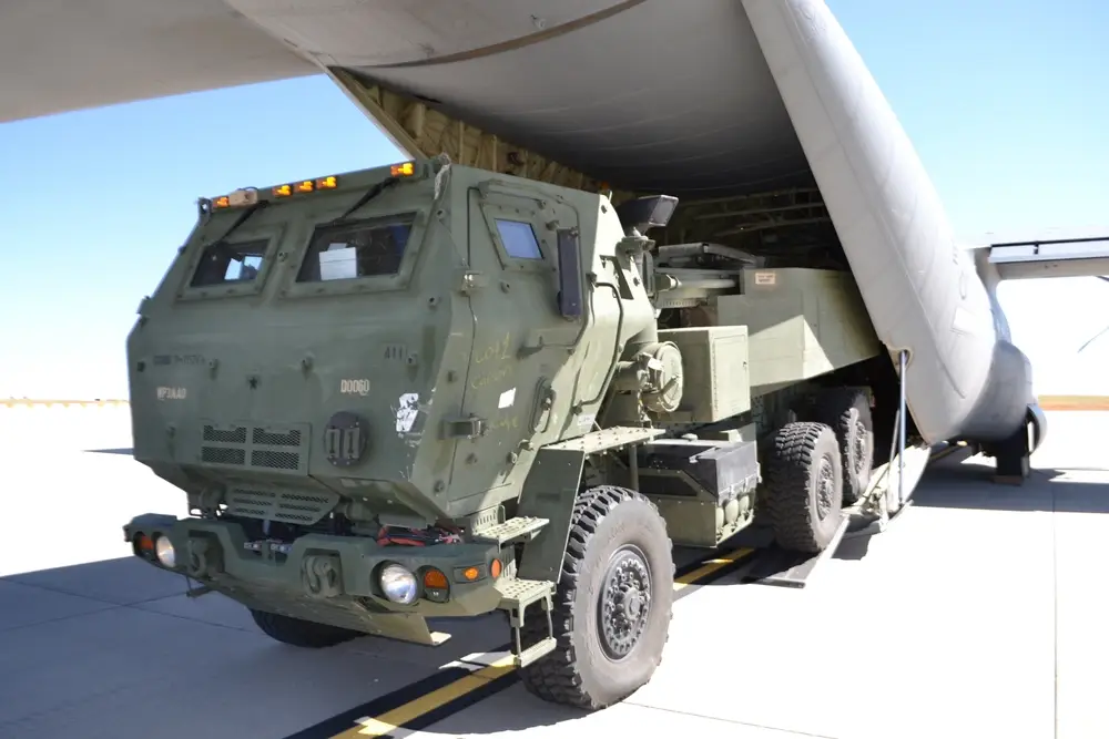 <em>A HIMARS is loaded onto a C-130 (U.S. Army)</em>