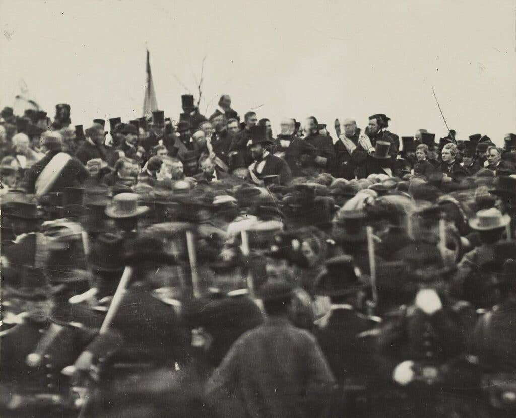 One of the two confirmed photos of Lincoln (center, facing camera) at Gettysburg, taken about noon, just after he arrived and some three hours before his speech. To his right is his bodyguard, <a href="https://en.wikipedia.org/wiki/Ward_Hill_Lamon">Ward Hill Lamon</a>. (Public domain)