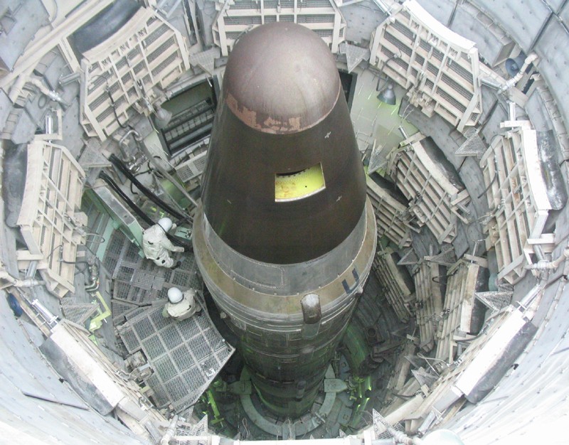 An ICBM loaded into the silo of the Titan Missile Museum, with a hole cut into the side of the nose cone to show that the weapon is inert.