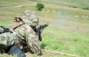 <em>A Ukrainian soldier fires an AK style rifle at a UK training site (MOD)</em>