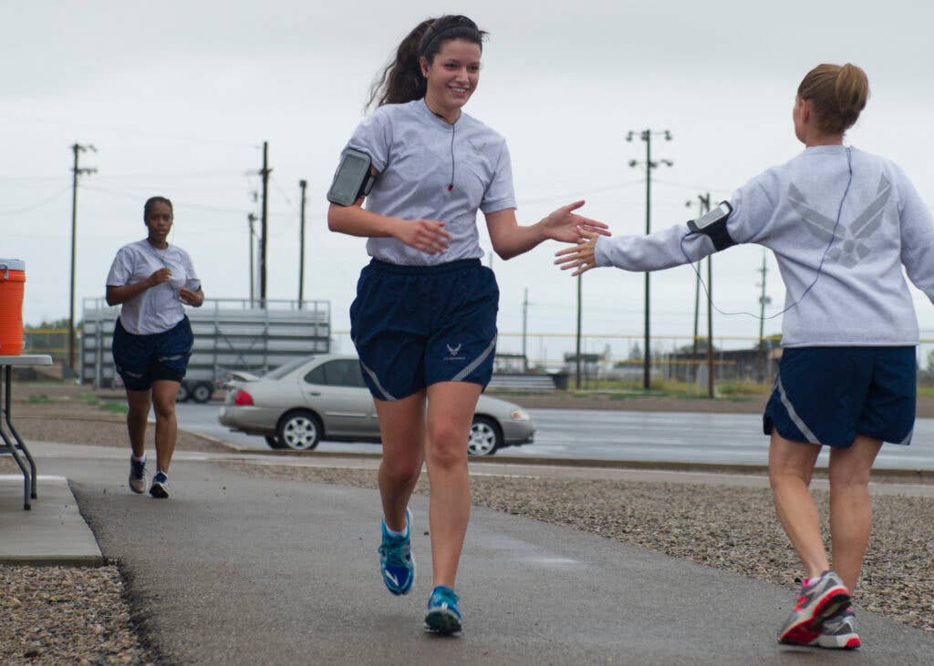 Chief Master Sgt. Wendy Rowe, 49th Materiel Maintenance Group, encourages Airman 1st Class Madeline Ericson, 49th Wing Judge Advocate civil law paralegal, as she finishes the Air Force Birthday 5K at Holloman Air Force Base, N.M., Sept. 18. On Sept. 18, 1947, the U.S. Air Force was officially recognized as an independent military service, leaving behind its former role, the U.S. Army Air Corps. This year marks 67 years of the USAF leading the world in air superiority, space and cyberspace. "The future of our nation is forever bound up in the development of Air Power," Brig. Gen. Billy Mitchell, United States Army Air Service. (U.S. Air Force photo by Senior Airman Leah Ferrante/Released)