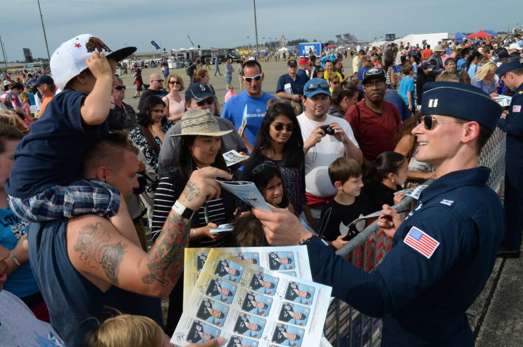 U.S. Air Force Capt. Ryan Bodenheimer, Thunderbird 2, signs autographs after the Joint Base Lewis-McChord Airshow and Warrior Expo, Aug. 28, 2016, at Tacoma, Wa. (U.S. Air Force Photo by Senior Airman Tabatha McCarthy)