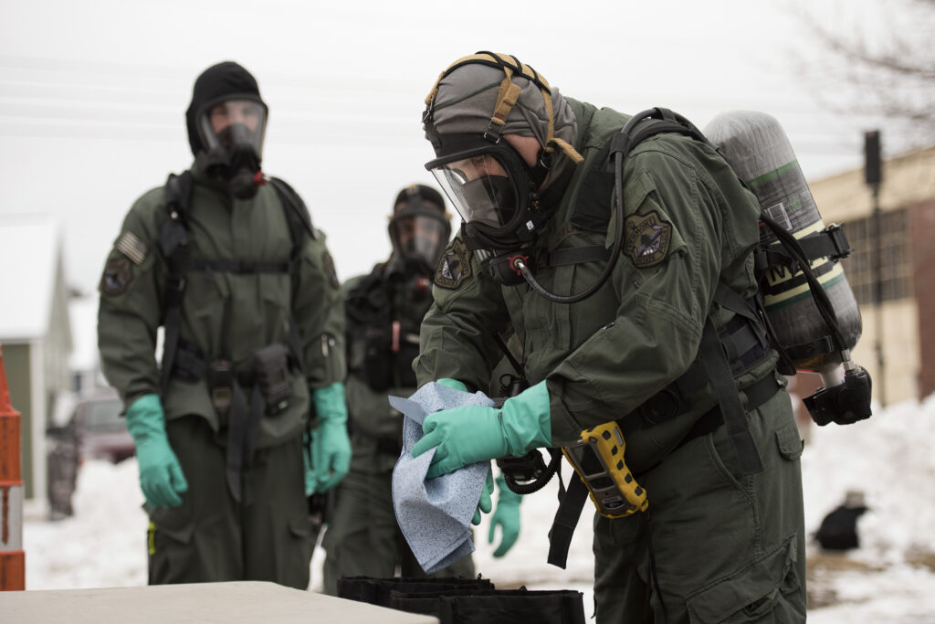 A member of the State of Vermont’s HAZMAT Team, simulates decontamination processes as part of a training exercise at St. Michael’s College, Colchester, Vt., January 18, 2017. In addition to HAZMAT, members from the Vermont State Police Clandestine Lab, the State Bomb Squad and the Vermont National Guard’s 15th Civil Support Team, all worked together optimizing inter-agency communications, while utilizing personnel and equipment to analyze simulated hazardous substances. (U.S. Air National Guard photo by Tech. Sgt. Sarah Mattison)