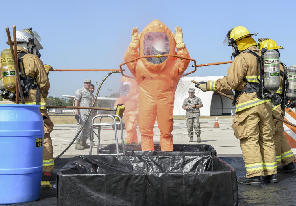U.S. Air Force Staff Sgt. Franklin Clay, 144th Civil Engineering Squadron firefighter, goes through a decontamination container during a hazardous material training exercise at the Fresno Air National Guard Base July 16, 2017. U.S. Air Force firefighters are trained to deal with dangerous chemical and other hazardous materials that they may encounter in real world situations.