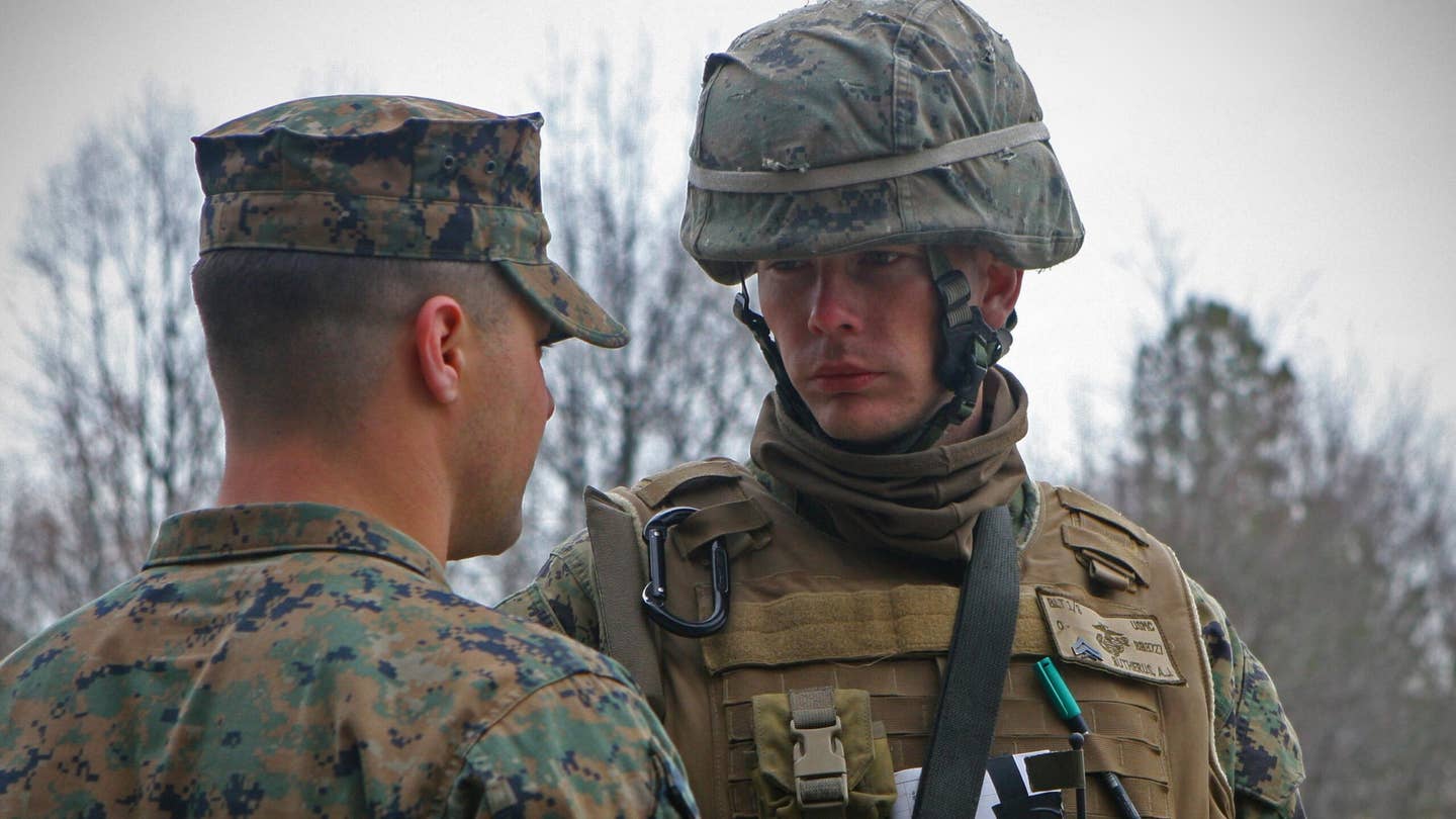 FORT PICKETT, VA - Sergeant Anthony V. Palmer (left), a squad leader with Company G, 2nd Battalion, 6th Marine Regiment, 2nd Marine Division, speaks with Cpl. Adam J. Butherus, a squad leader with Company B, 1st Battalion, 9th Marine Regiment, 2nd Marine Division, before a patrol. (USMC photo)