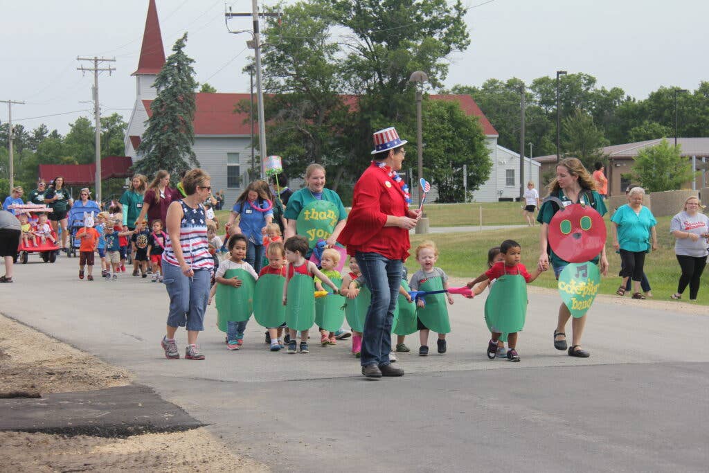 Students and staff members of Fort McCoy, Wis., Child and Youth Services march down South F Street during a parade celebrating the Army Birthday on June 15, 2018, at the installation. Children attending the Child Development Center and the School Age Center/Youth Center’s summer camp programs put on the parade for parents and Fort McCoy community members in honor of the Army’s 243rd birthday. (U.S. Army Photo by Aimee Malone, Public Affairs Office, Fort McCoy, Wis.)