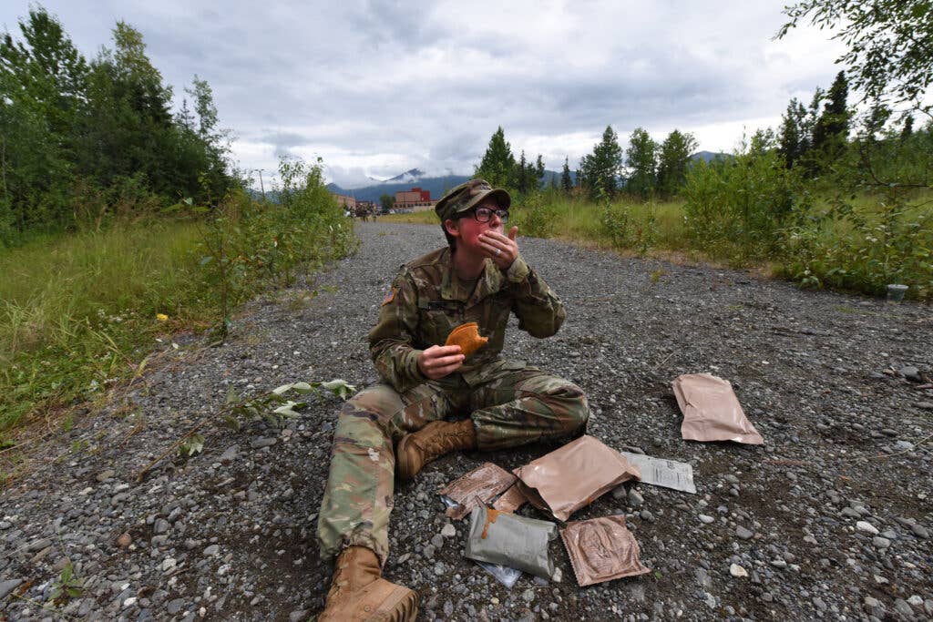 U.S. Army Sgt. Jess Flores from Charlie Company, 725th Brigade Support Battalion (Airborne), 4th Infantry Brigade Combat Team (Airborne), 25th Infantry Division, eats a soft taco Meal-Ready-to-Eat (MRE) in between grading soldiers who were participating in a “best Medic” competition, July 26, 2018 at Joint Base Elmendorf-Richardson, Alaska. The “Cobra Medics” conducted a four day challenge to select two medics to be sent as competitors to the USARAK best medic competition. (U.S. Air Force photo by Jamal Wilson)