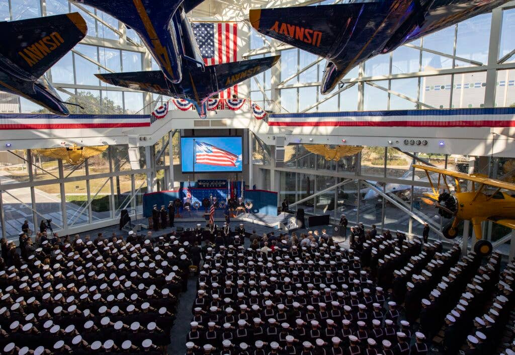 PENSACOLA, Fla. (Dec. 19, 2019) Guests attend a memorial service in the National Naval Aviation Museum at Naval Air Station Pensacola, Dec. 19, 2019. The service was held for Ensign Joshua K. Watson, Naval Air Crewman (Mechanical) 3rd Class Mohammed S. Haitham, and Naval Air Crewman (Mechanical) 3rd Class Cameron S. Walters. The three Sailors were killed during the Dec. 6, 2019 active shooter incident on base. (U.S. Navy photo by Chief Mass Communication Specialist David Holmes/Released)