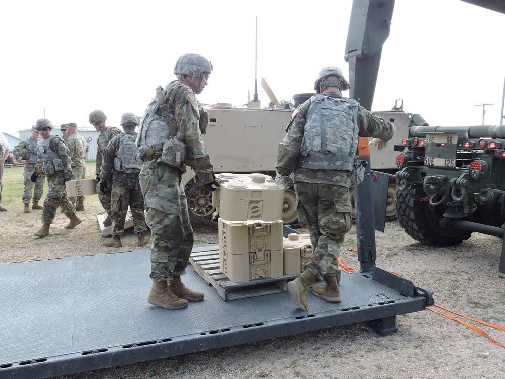 <em>Two soldiers carry an XM204 during testing at Fort Leonard Wood, Missouri (U.S. Army)</em>