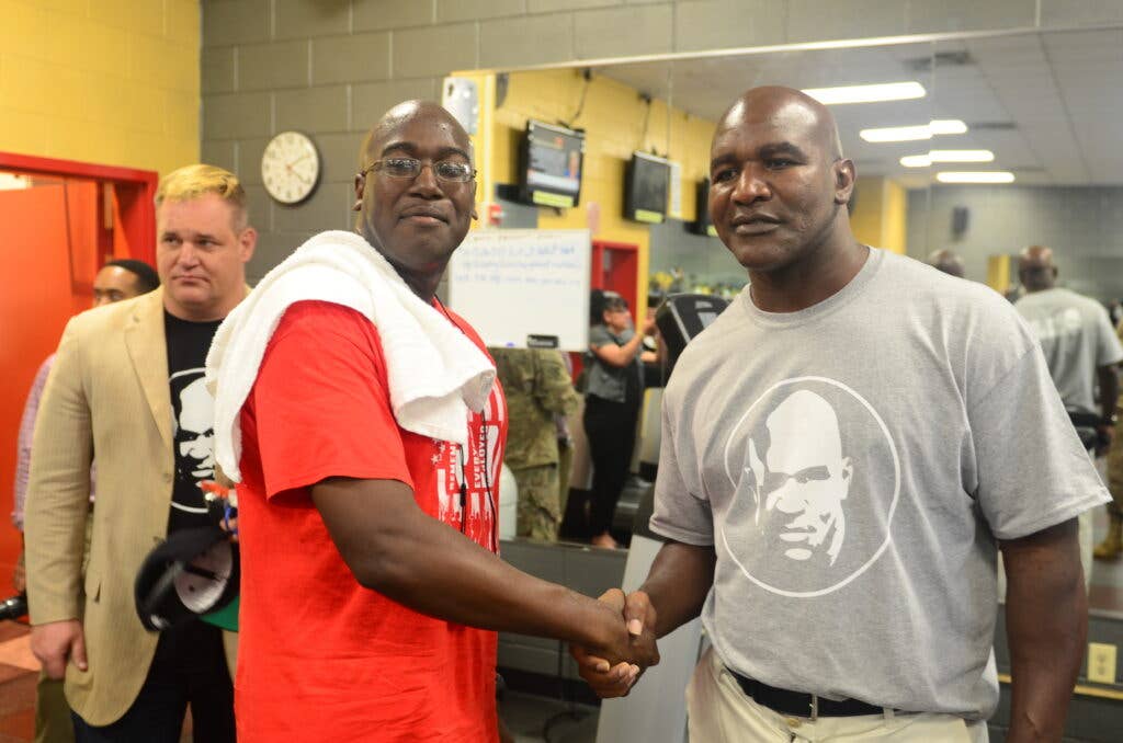 Sgt. Anderson Robert, an engineer Soldier from 92nd Engineer Battalion, 3rd Infantry Division Artillery shake hands with former professional boxer, Evander Holyfield, at Newman Gym Aug. 18 at Fort Stewart, Georgia. Holyfield thanked Soldiers for their hard work and sacrifice.