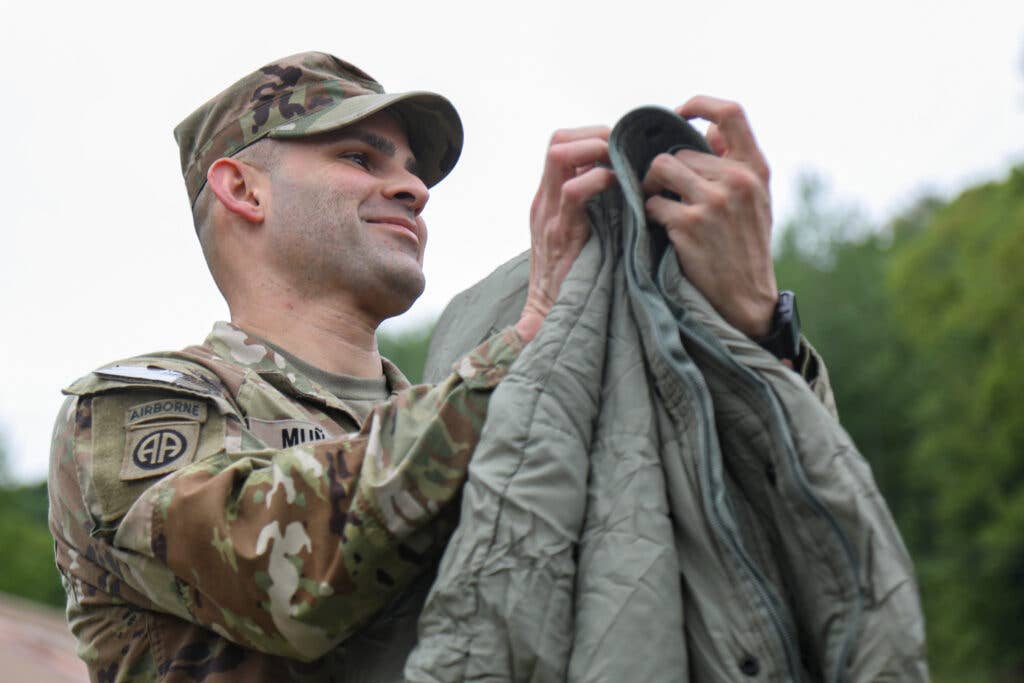 soldier folding a sleeping bag