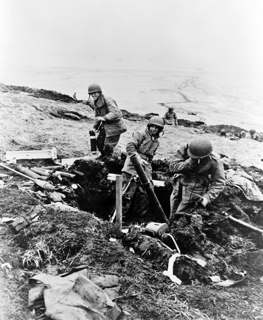Attu, Aleutian Island in Alaska. Soldiers hurling their trench mortar shells over a ridge into a Japanese position