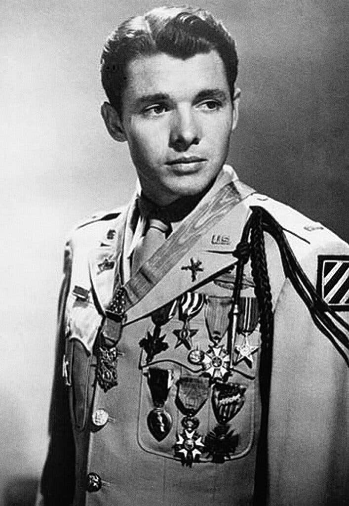 Audie Murphy photographed in 1948 wearing the U.S. Army khaki "Class A" (tropical service) uniform with full-size medals.