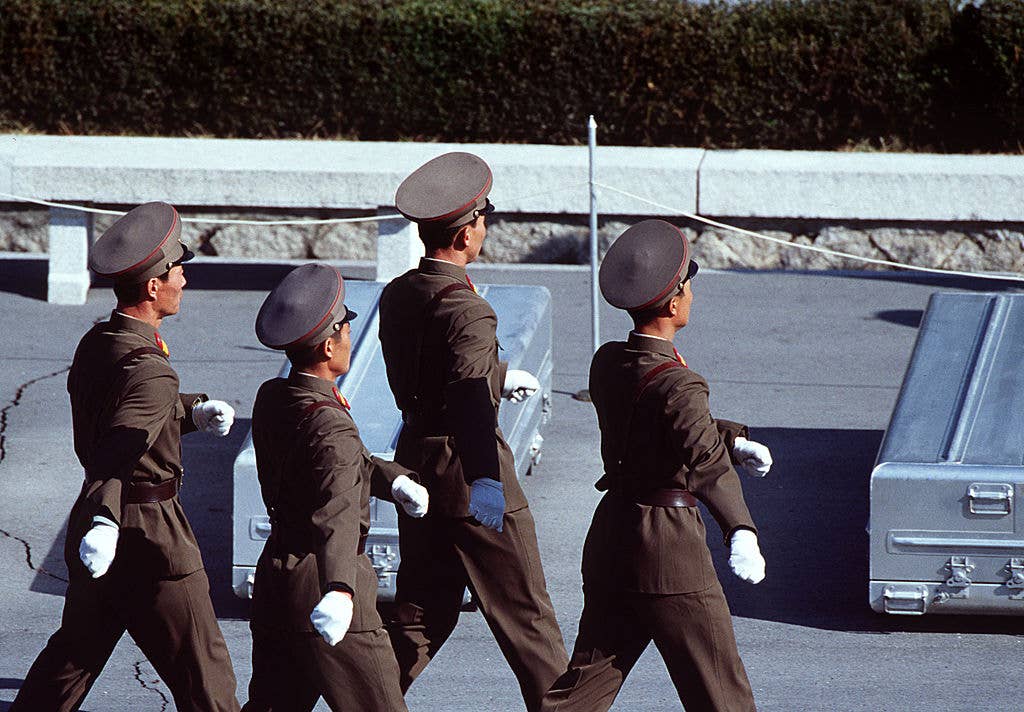 north korean troops wearing giant hats