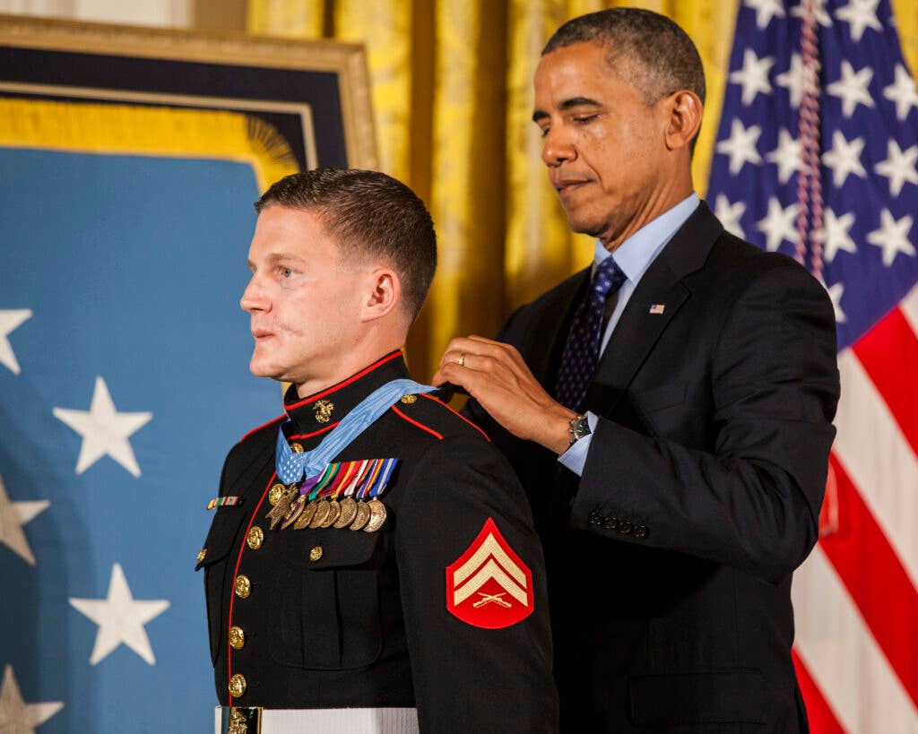 President of the United States, Barrack H. Obama places the Medal of Honor around retired U.S. Marine Corps Cpl. William Kyle Carpenter's neck, inside the East Wing of the White House, June 19, 2014. (U.S. Marine Corps photo by Cpl. Michael C. Guinto/Released)
