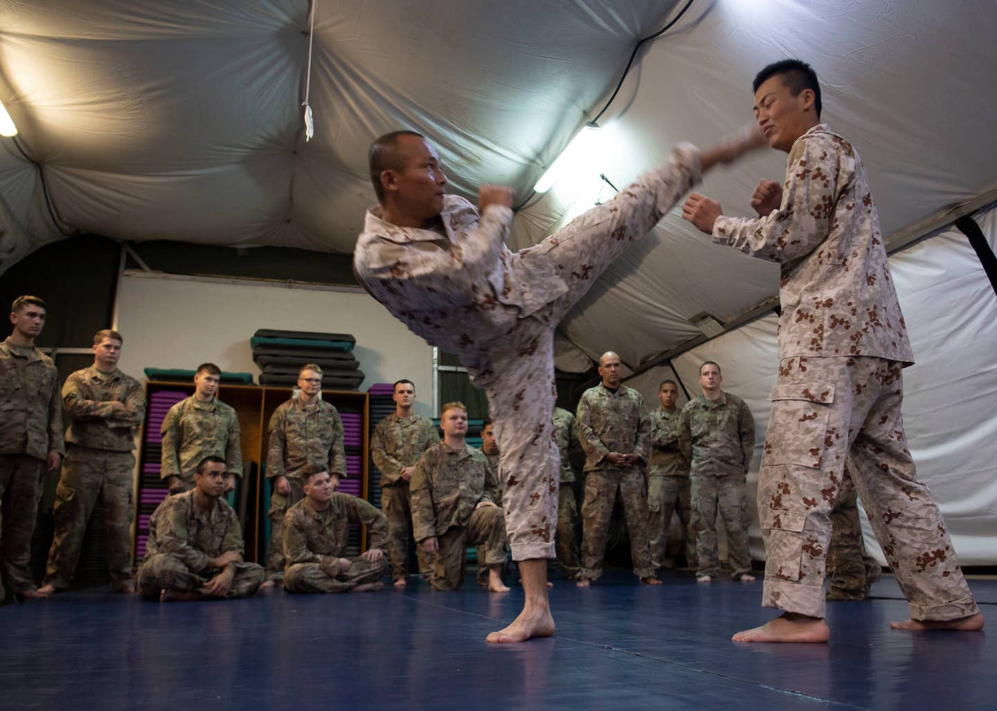 Japanese Ground Self-Defense Force Command Sgt. Maj. Kentaro Nakazato, command sergeant major of the 16th infantry regiment company, demonstrates head kick form during a combatives exchange with Combined Joint Task Force-Horn of Africa. (U.S. Air Force photo by Staff Sgt. J.D. Strong II)