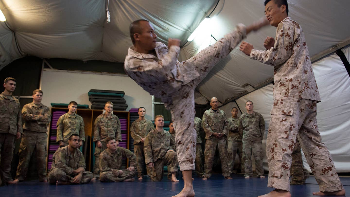 Japanese Ground Self-Defense Force Command Sgt. Maj. Kentaro Nakazato, command sergeant major of the 16th infantry regiment company, demonstrates head kick form during a combatives exchange with Combined Joint Task Force-Horn of Africa. (U.S. Air Force photo by Staff Sgt. J.D. Strong II)