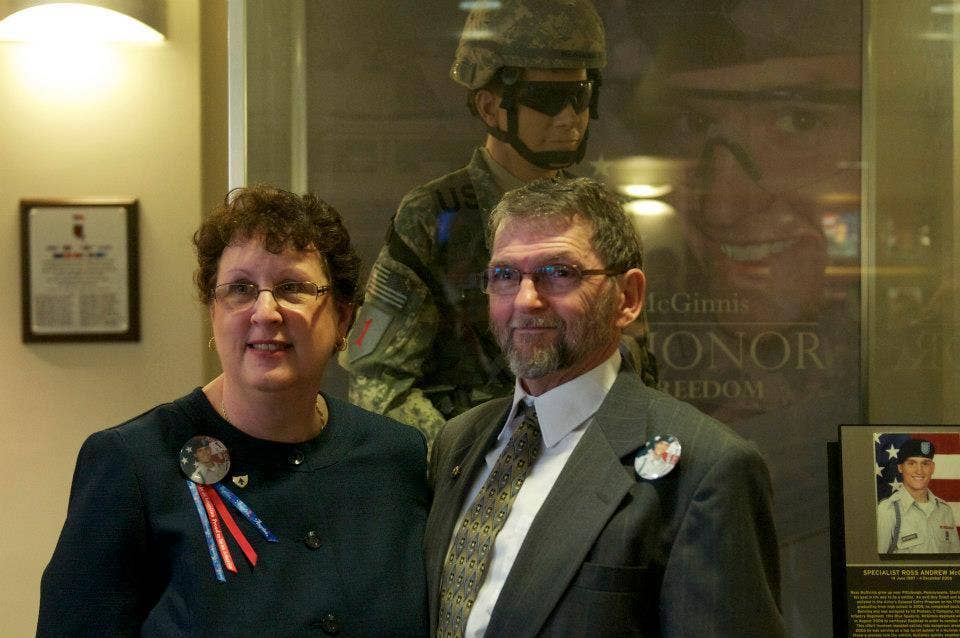 Tom and Romayne McGinnis, parents of the late Spc. Ross McGinnis, stand before a mannequin replica of their son after he was presented as a Medal of Honor recipient during a dedication ceremony held at the 3rd Infantry Brigade Combat Team, 1st Infantry Division headquarters.