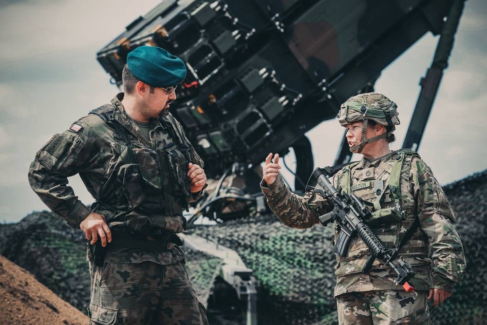polish and american troops with patriot missiles