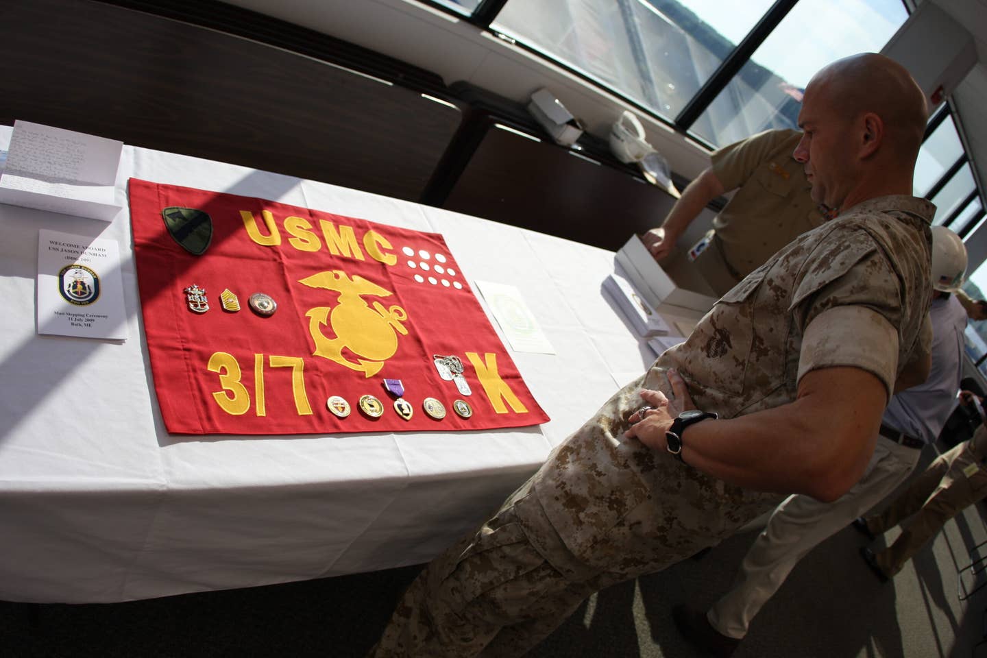 Maj. Trent A. Gibson, the executive officer for 2nd Battalion, 7th Marine Regiment, and Medal of Honor recipient Corporal Jason Dunham's former company commander, admires the display of items that were permanently sealed in the destroyer, the USS Jason Dunham.