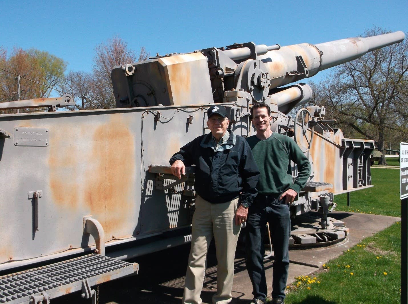 Bill Wieberg and Ken Wieberg, son, gather in front of the gun they travelled from St. Louis to see, Atomic Annie, at Rock Island Arsenal’s Memorial Field, April 18. (Photo by Joe Ammann)