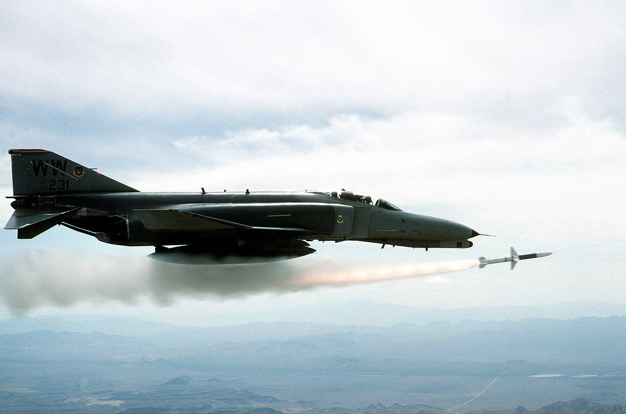 An F-4 phantom launches a missile in the sky