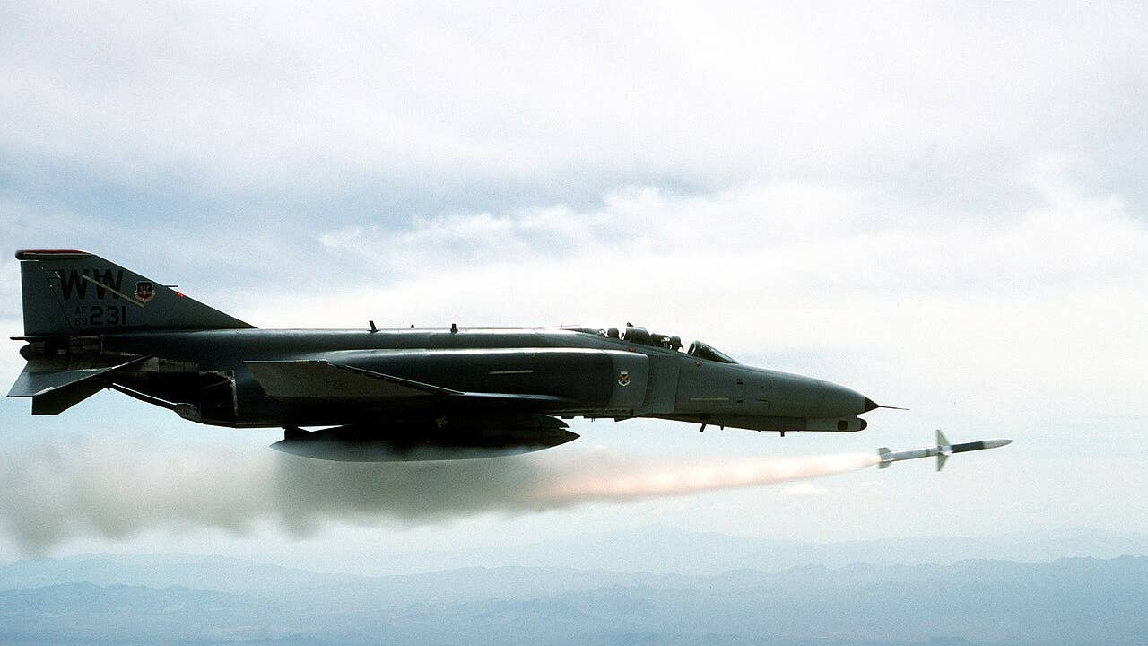 An F-4 phantom launches a missile in the sky