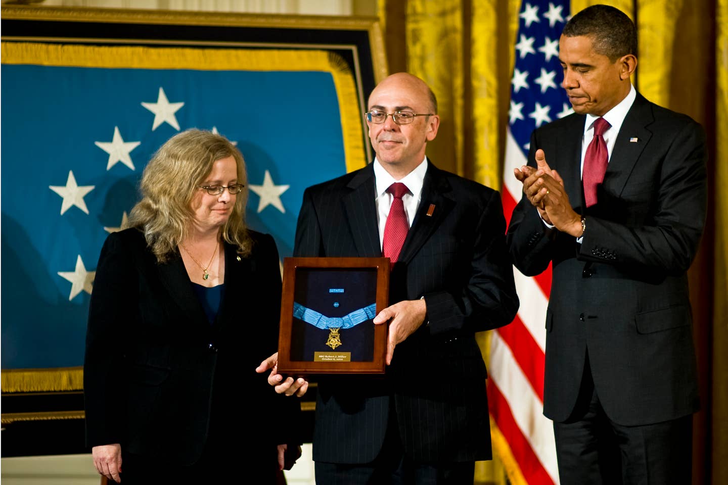 President Barack Obama presents the Medal of Honor posthumously to Phil and Maureen Miller, the parents of U.S. Army Staff Sgt. Robert J. Miller, in the East Room of the White House, Oct. 6, 2010. Miller received the honor for his heroic actions on Jan. 25, 2008, in Afghanistan where he sacrificed his life to save the lives of his teammates and 15 Afghanistan soldiers.
