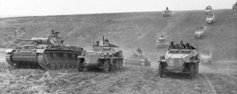 Tanks and mechanised infantry of the 24th Panzer Division advancing through Ukraine, June 1942, typifying fast-moving combined arms forces of classic blitzkrieg.