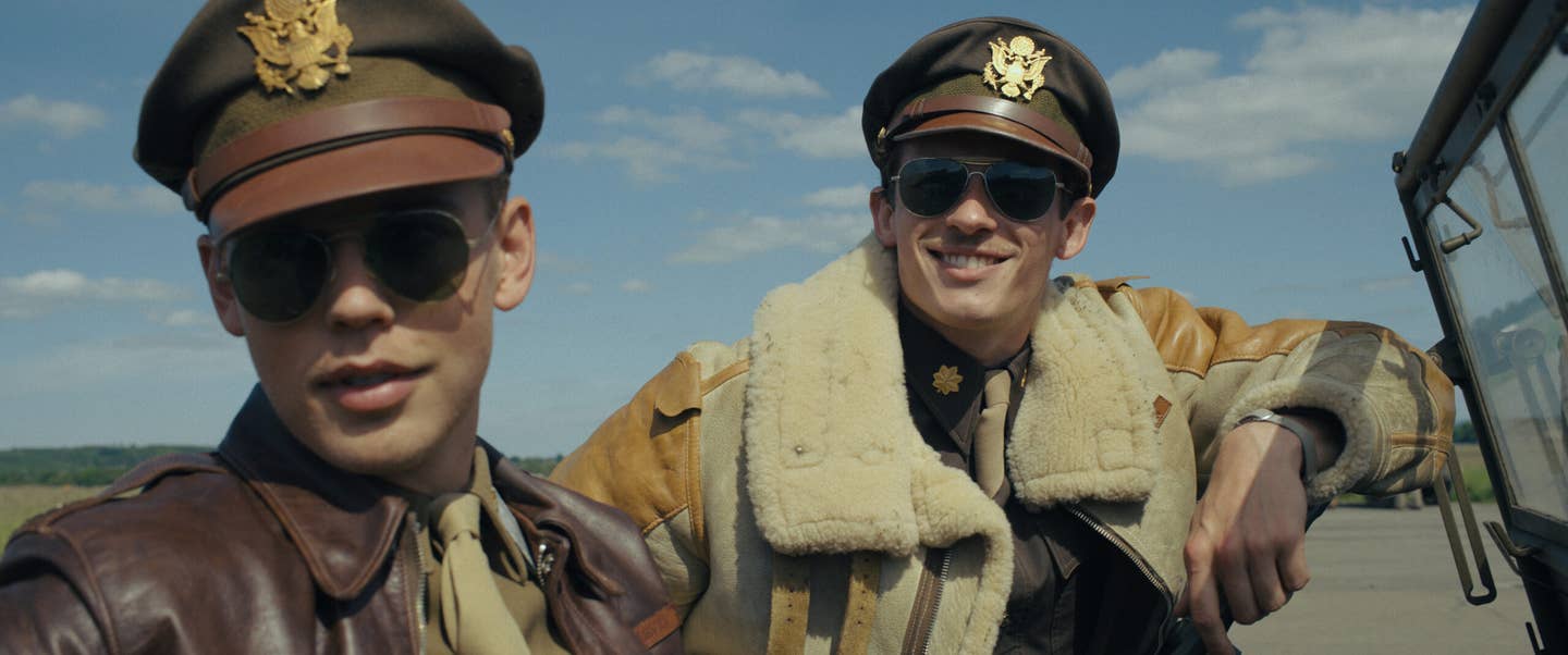 Two pilots standing at airfield in Masters of the Air.
