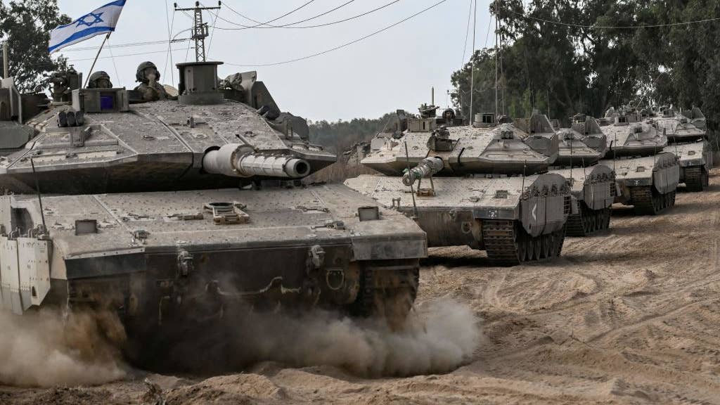 Israeli army Merkava battle tanks deploy along the border with the Gaza Strip.