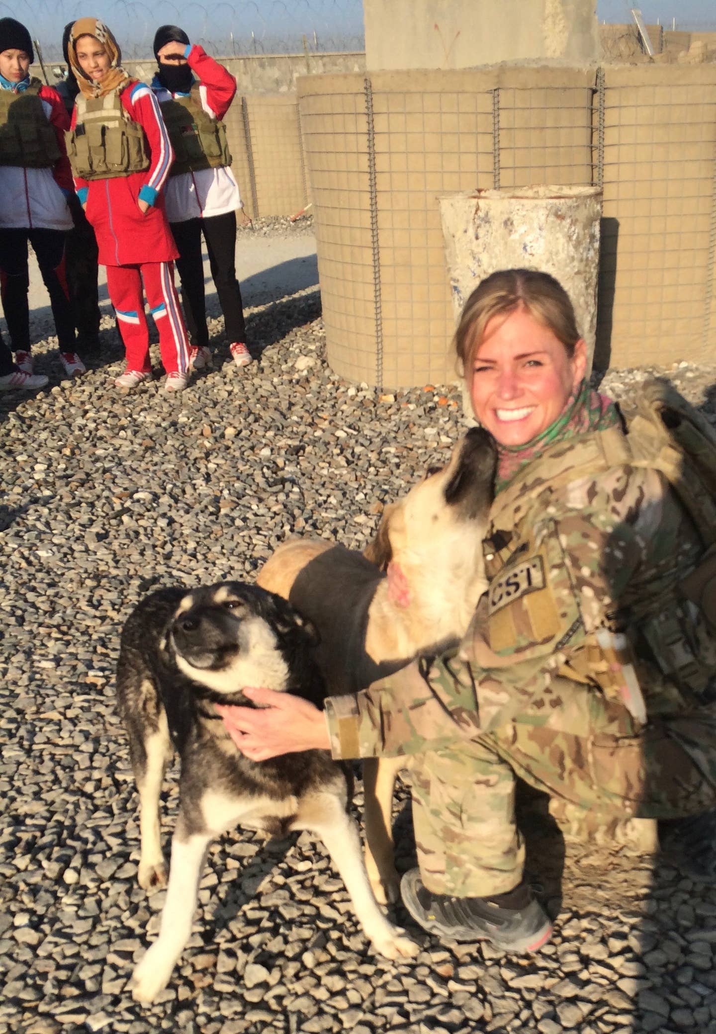Rebekah Edmonson petting a dog in Afghanistan.