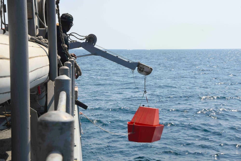 A live-fire target is lowered into the water during Exercise Digital Talon.