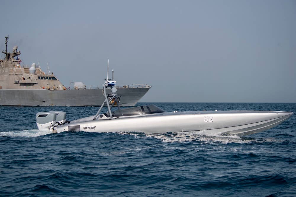 A T38 Devil Ray sails with USS Sioux City (LCS-11).