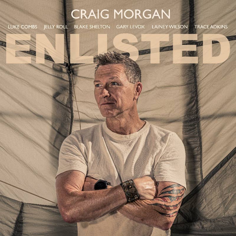 Craig Morgan standing with arms crossed in white tshirt.