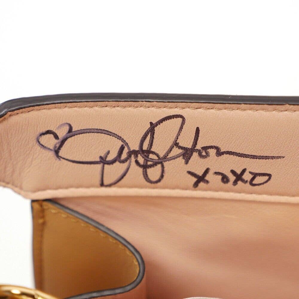 <em>Aniston's autograph inside the Fendi bag (HFOT via eBay)</em>