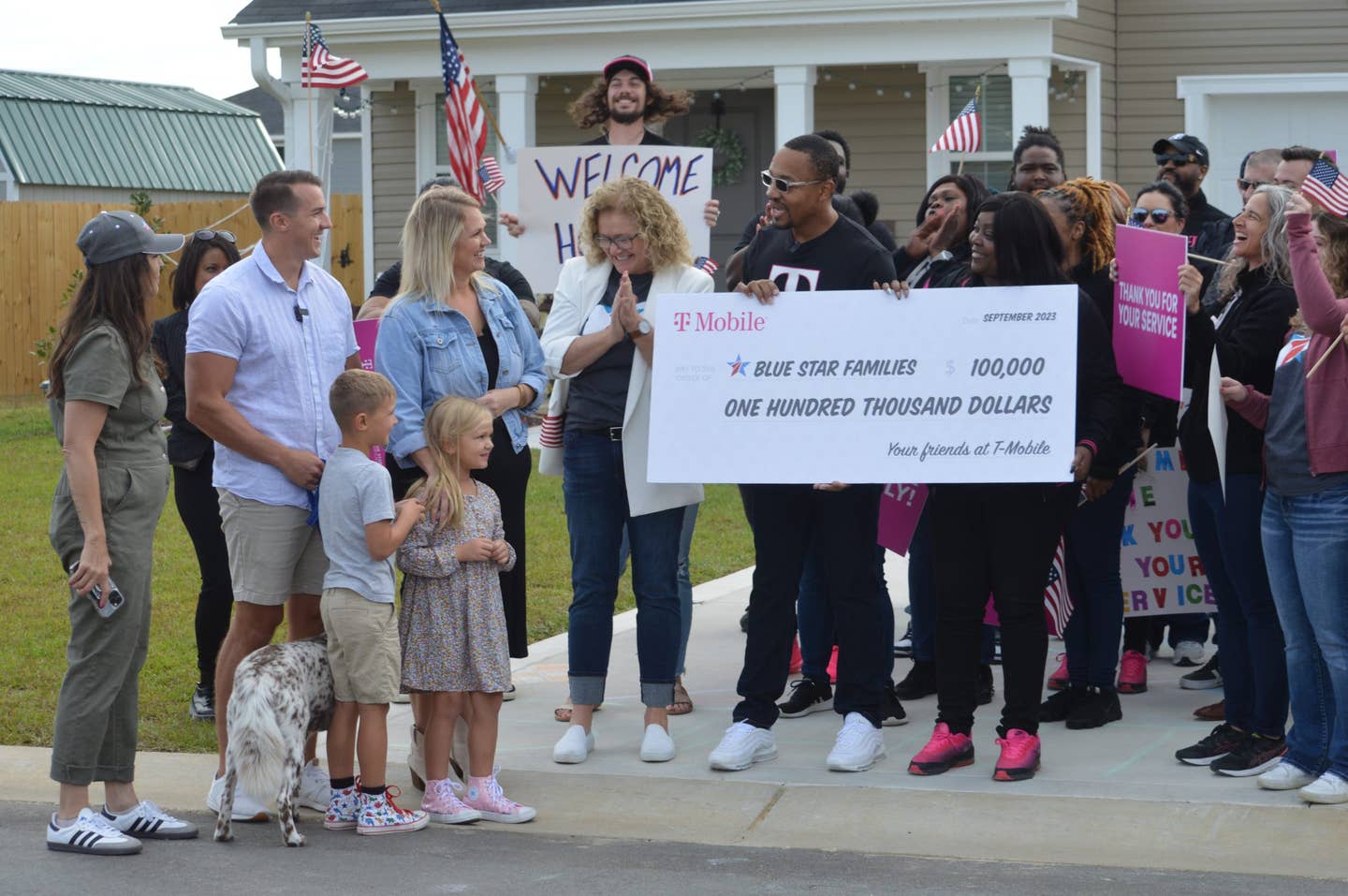 T-mobile presents a large check to Blue Star Families at a home makeover