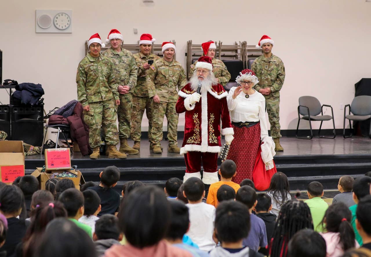 <em>Santa Claus, Mrs. Claus, and their National Guard helpers during Operation Santa Claus 2022 (Alaska National Guard)</em>