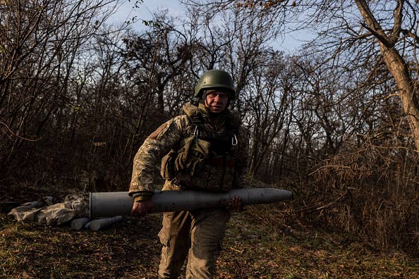 A ukrainian soldier carries artillery