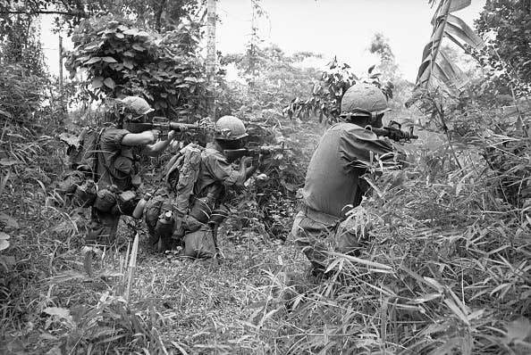 (Original Caption) Tam Ky, South Vietnam: Open Fire! Taking deadly aim, troopers of 101st Airborne Division fire into brush during Operation Wheeler, near here recently, while on a search and destroy mission. Getty Images.