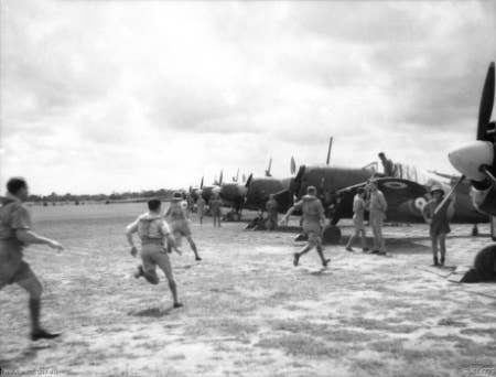 <em>No. 453 RAAF Squadron scramble to their planes (Public Domain)</em>